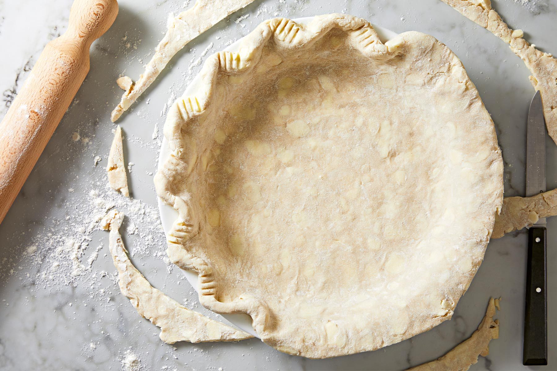 Trim pie crust to 1/2 in. beyond rim of plate; flute the edges.