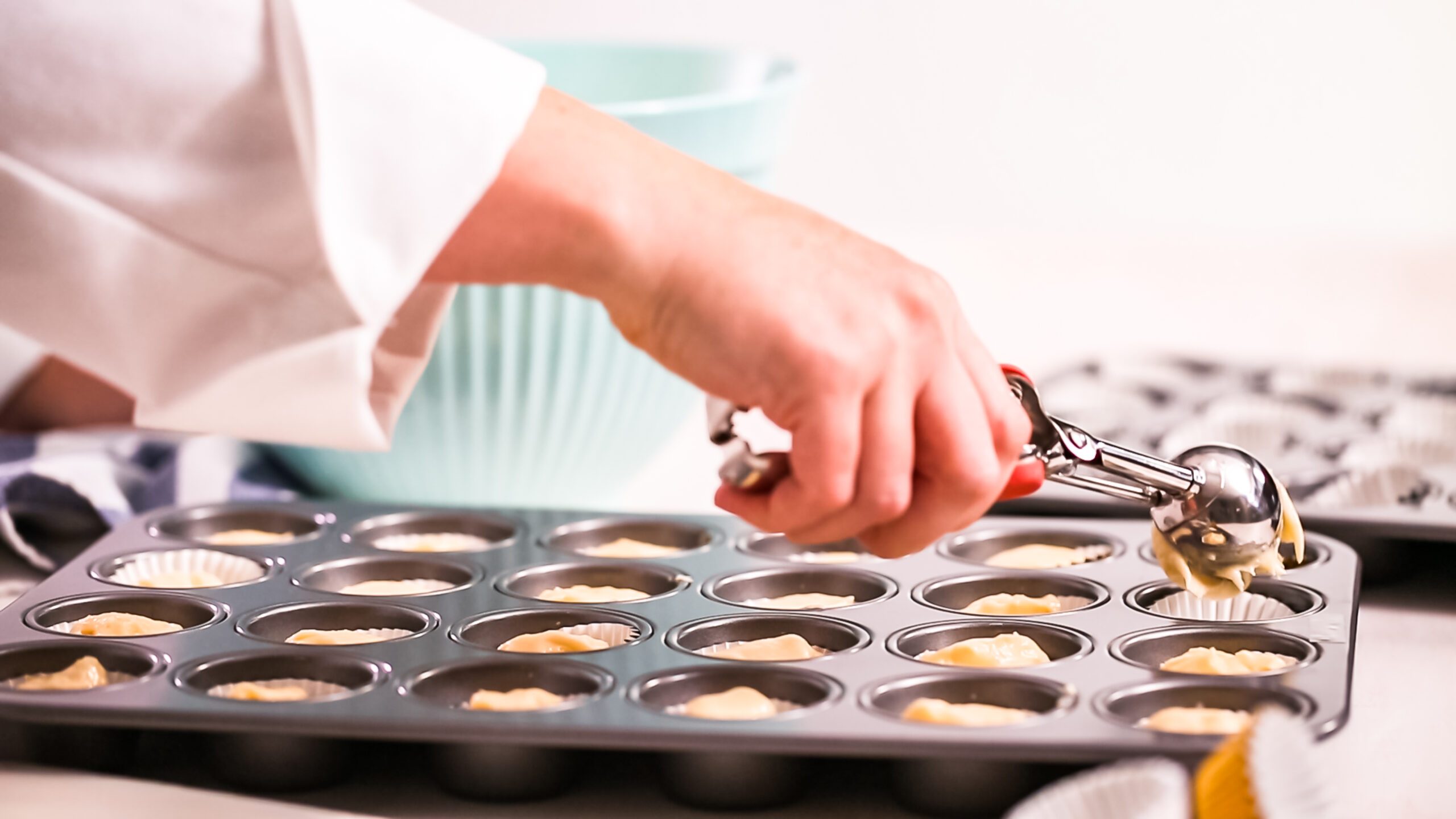 Scooping batter into cupcake liners with a cookie scoop