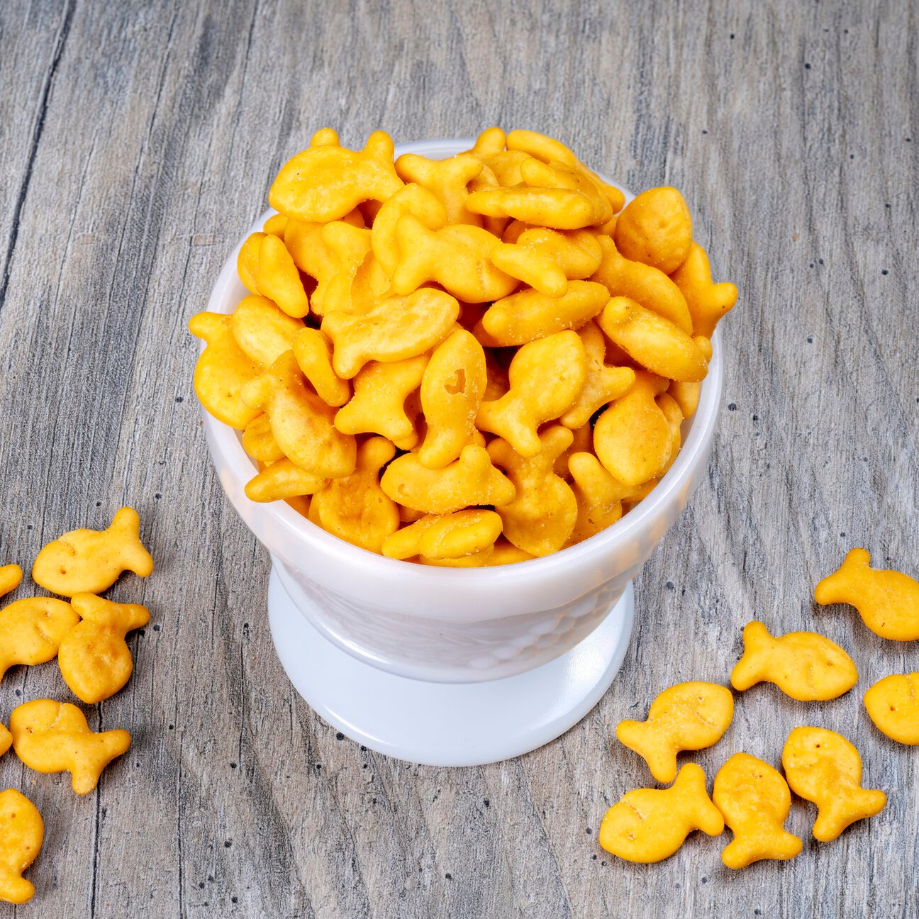 Orange cheddar flavored soup crackers in a white bowl
