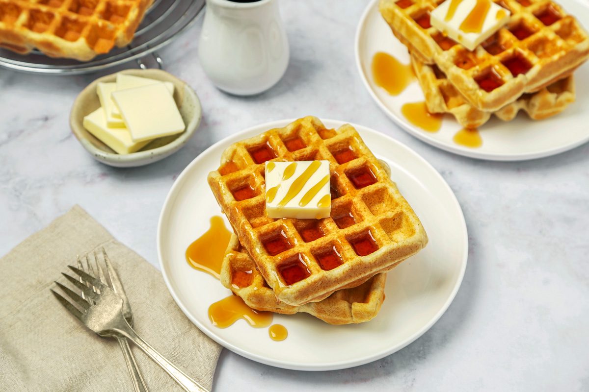 Gluten Free Waffles served on a plate with butter and maple syrup