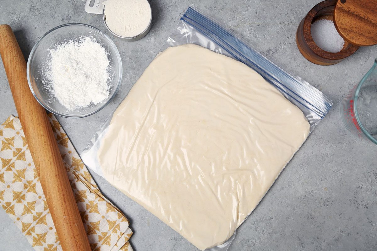 Dough rolled out in a large plastic food storage bag.