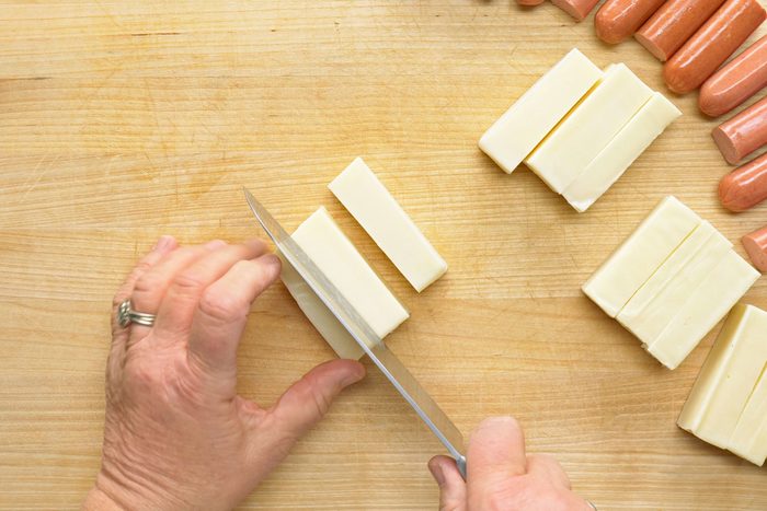 Chopping cheese into 2 inch logs