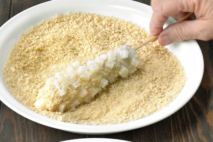 Hot dog and cheese skewer with potatoes rolled into bread crumbs