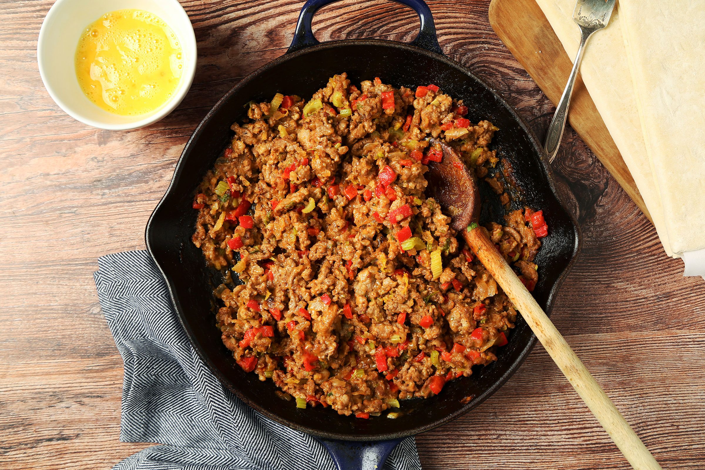 Beef, sausage, celery, sweet red pepper and onion cooked In a large skillet