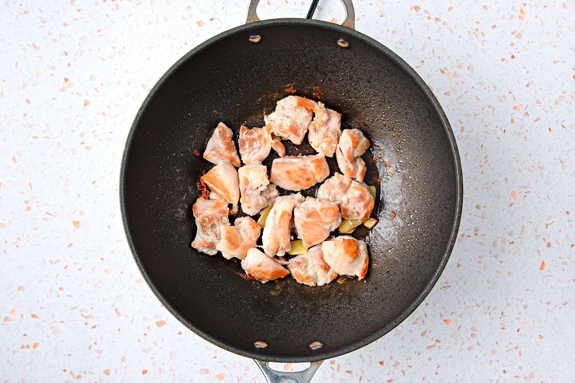 Heat oil in a large saute pan to medium-high heat. Add chicken pieces; brown on all sides,