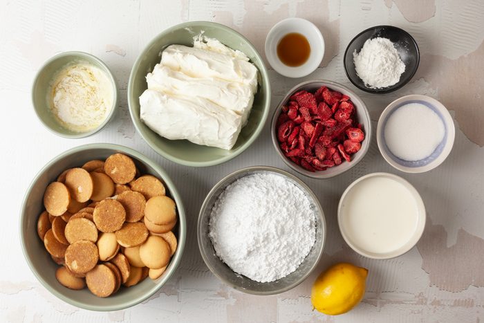 cream cheese, strawberries, sugar, whipping cream, vanilla wafers and crumbs for crust in separate bowls