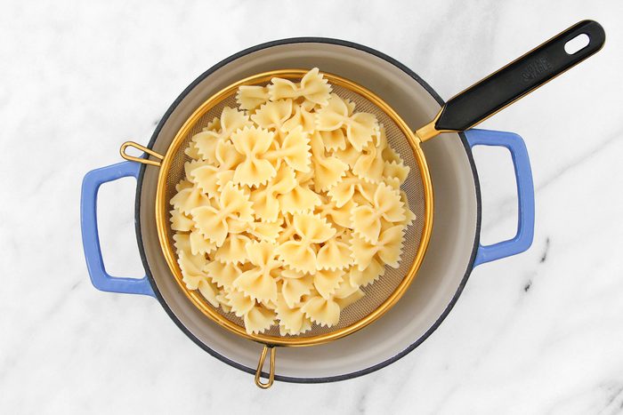 Overhead shot of cooked pasta being drained