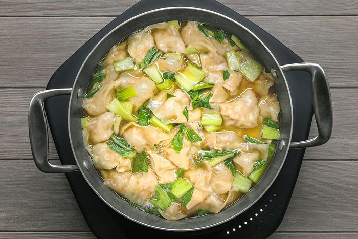 A large saucepan with freshly prepared wonton soup