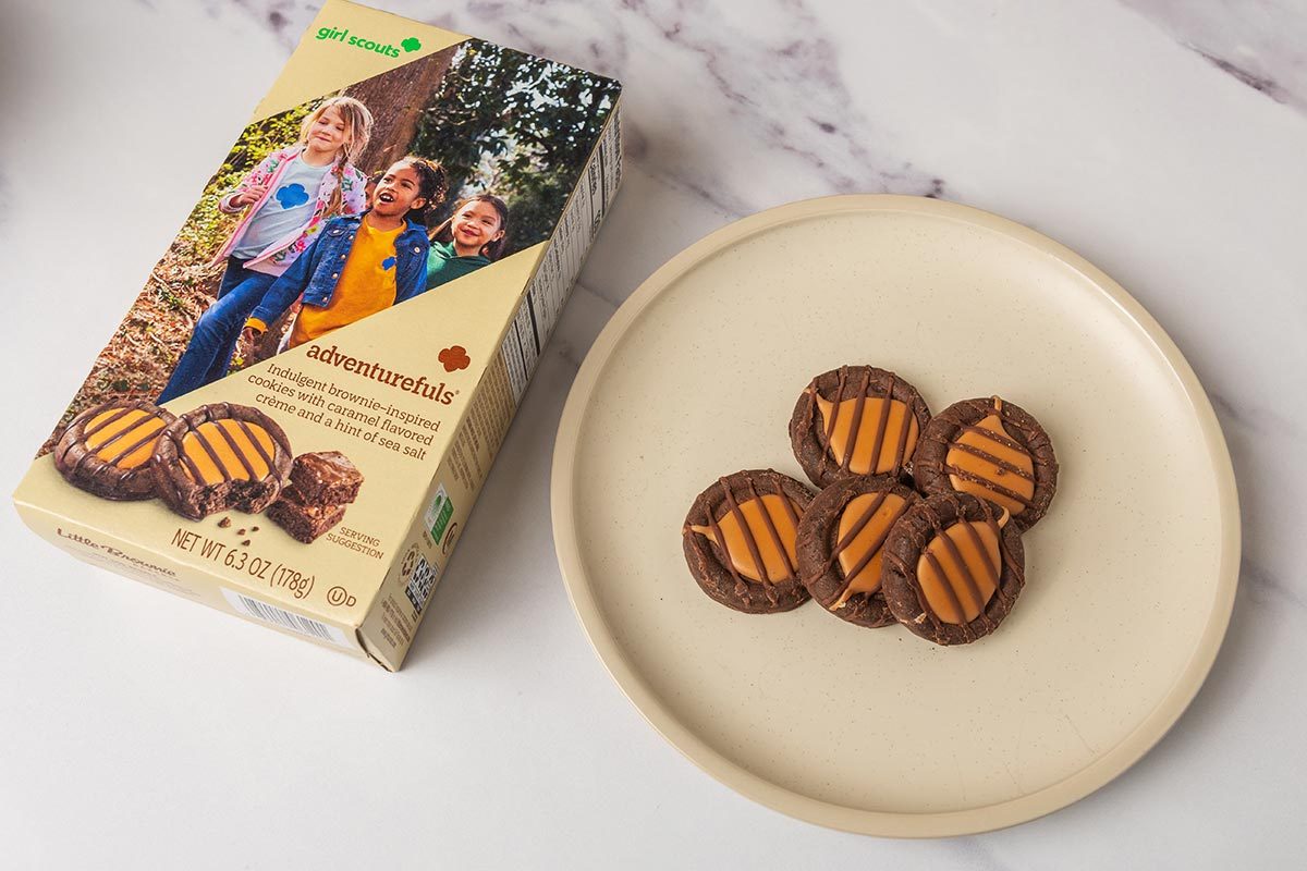 Package of Adventurefuls Girl Scout Cookies next to several cookies on a plate