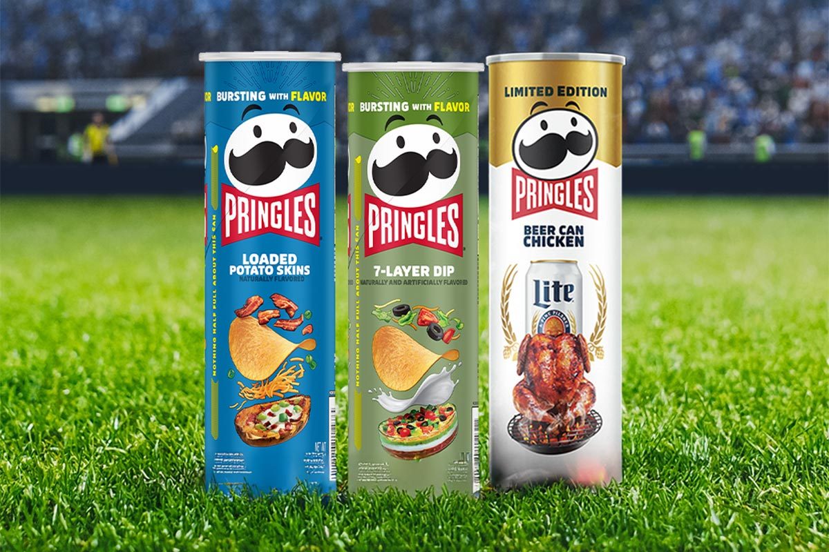 Three pringles cans: a blue "loaded potato salad" flavor, a green "7-layer dip" flavor, and a white "beer can chicken" flavor set on a football stadium background