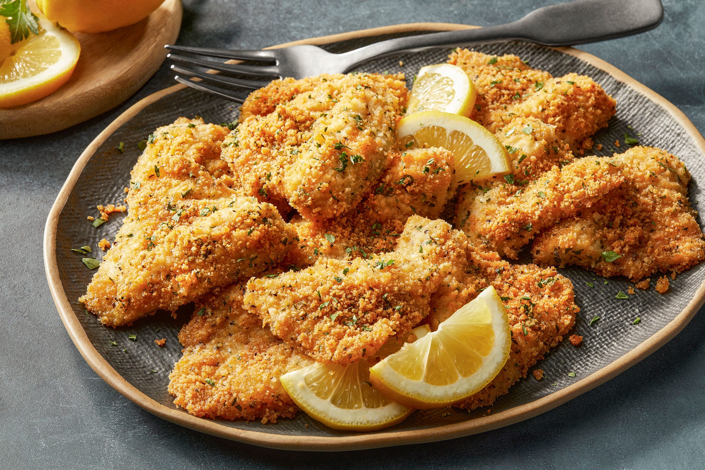 Baked Bluegill with lemon wedges on a plate