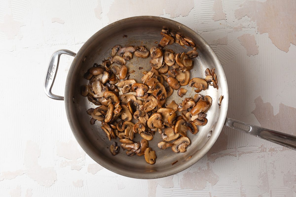 mushrooms being cooked in a skillet