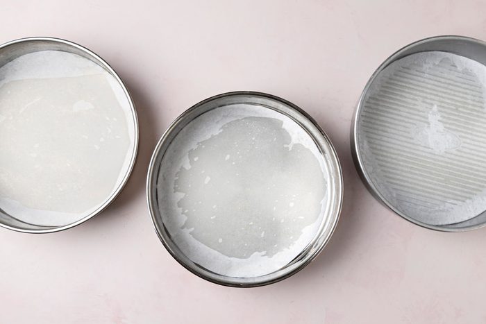 three greased 9-inch round baking pans with parchment.