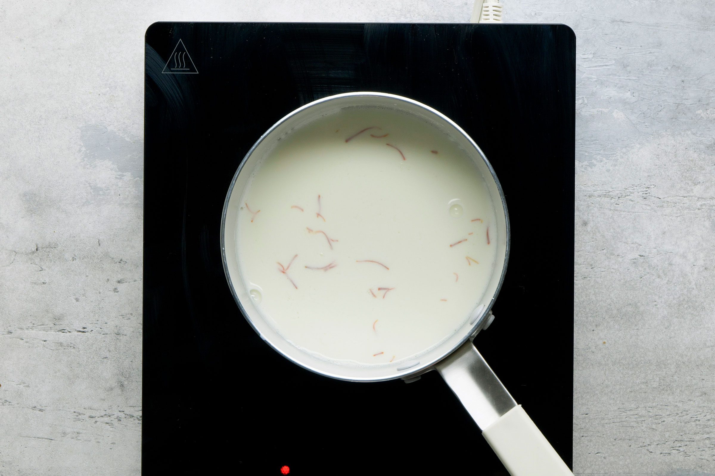 Milk and saffron heated in a small saucepan