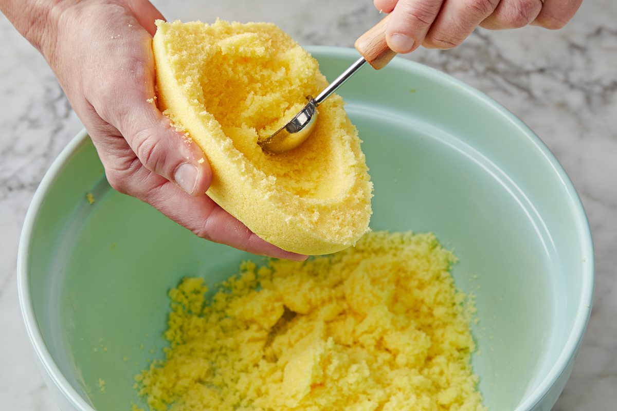 tablespoon being used to scoop out centre of egg