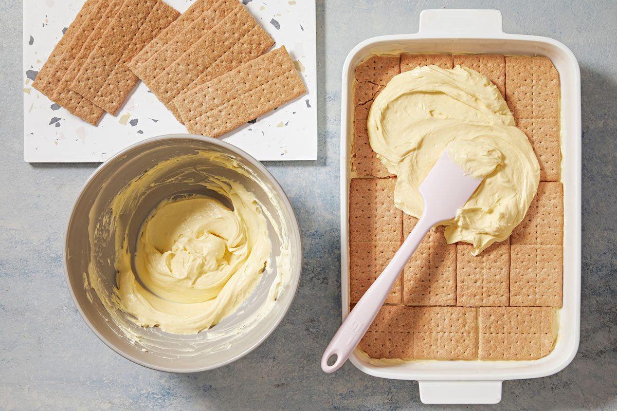 Spread 1/2 of the pudding mixture evenly over grahams, repeat layers