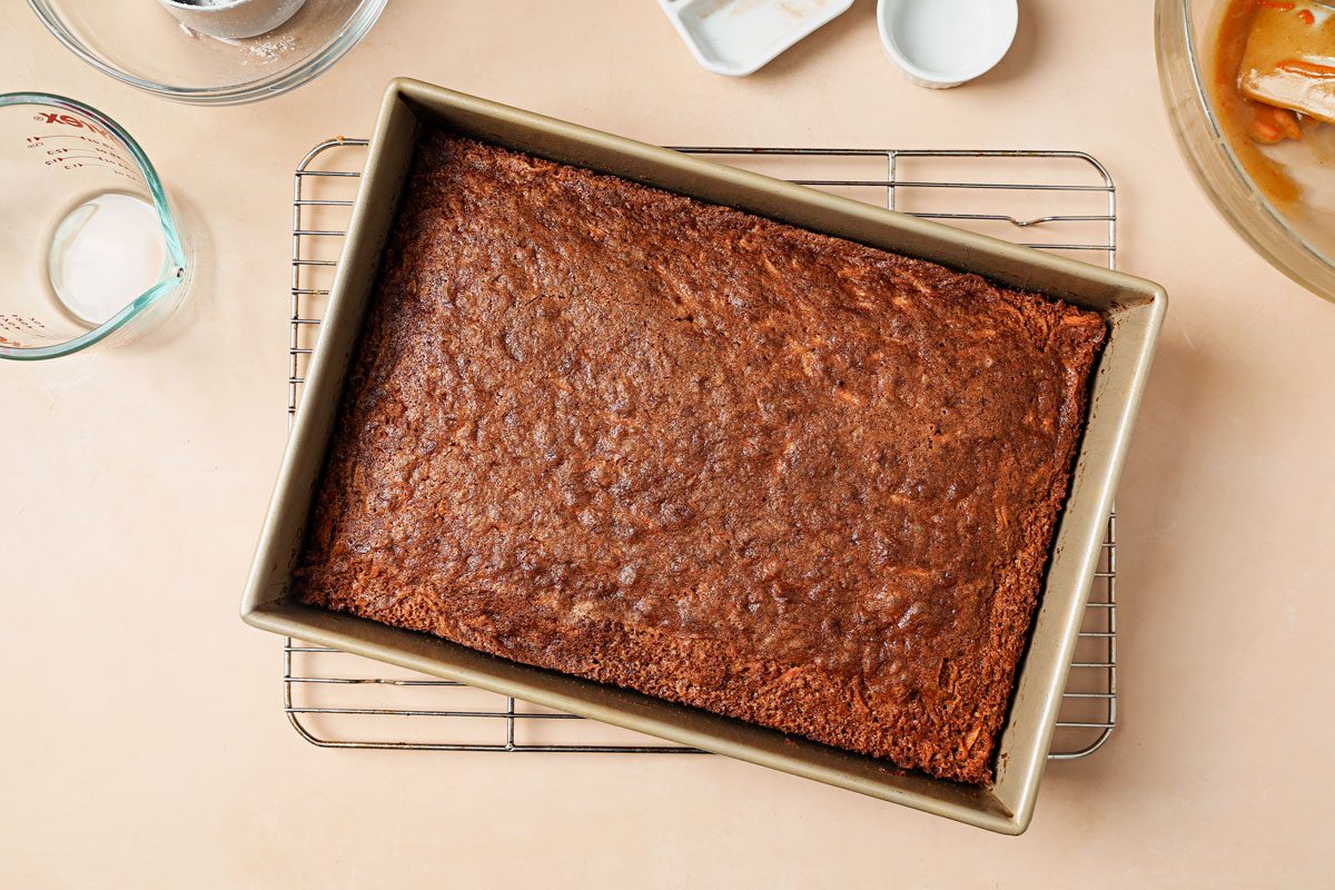 Baked carrot cake cooling on a wire rack.