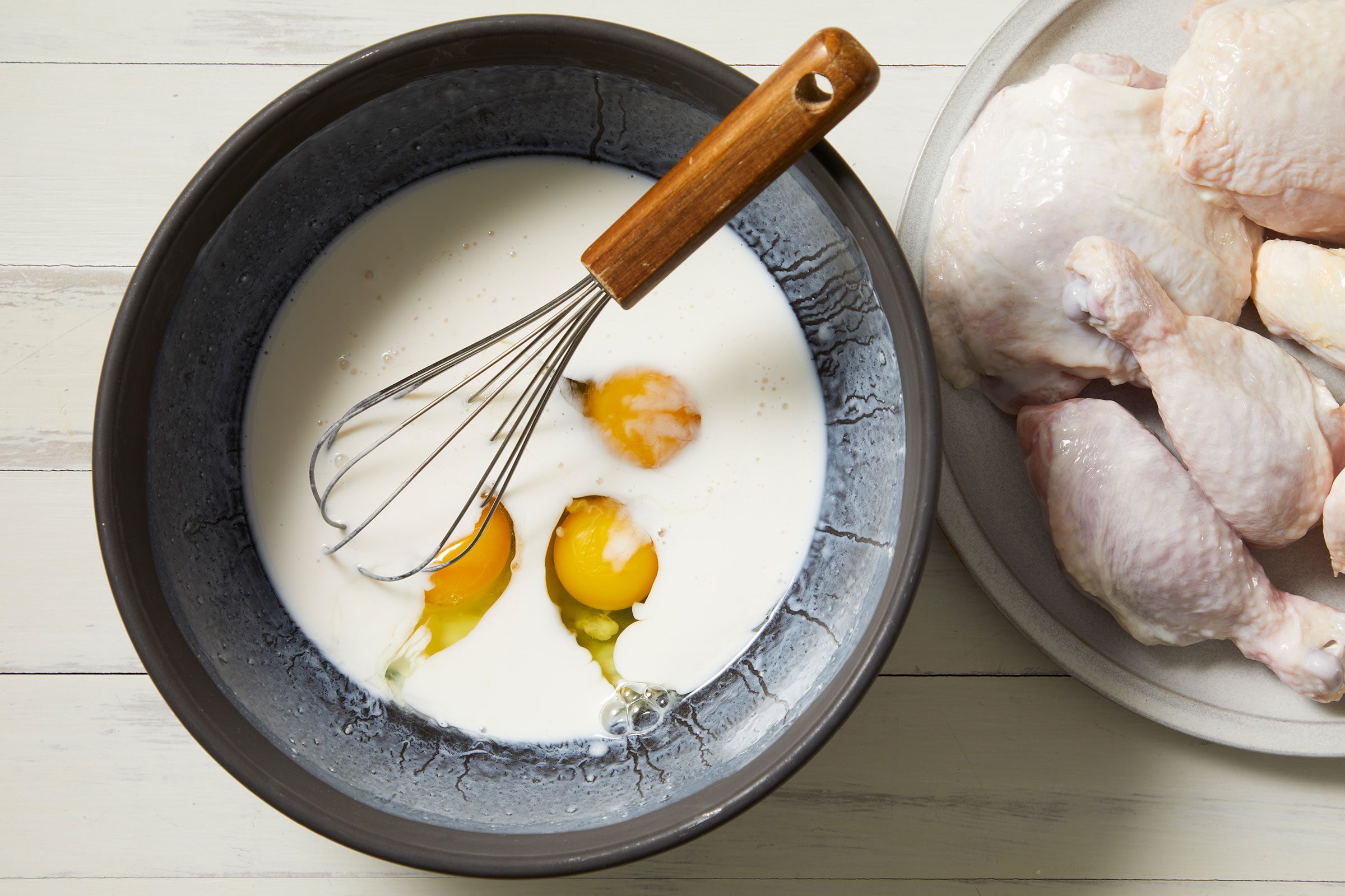 Eggs whisked into buttermilk mixture in a large bowl
