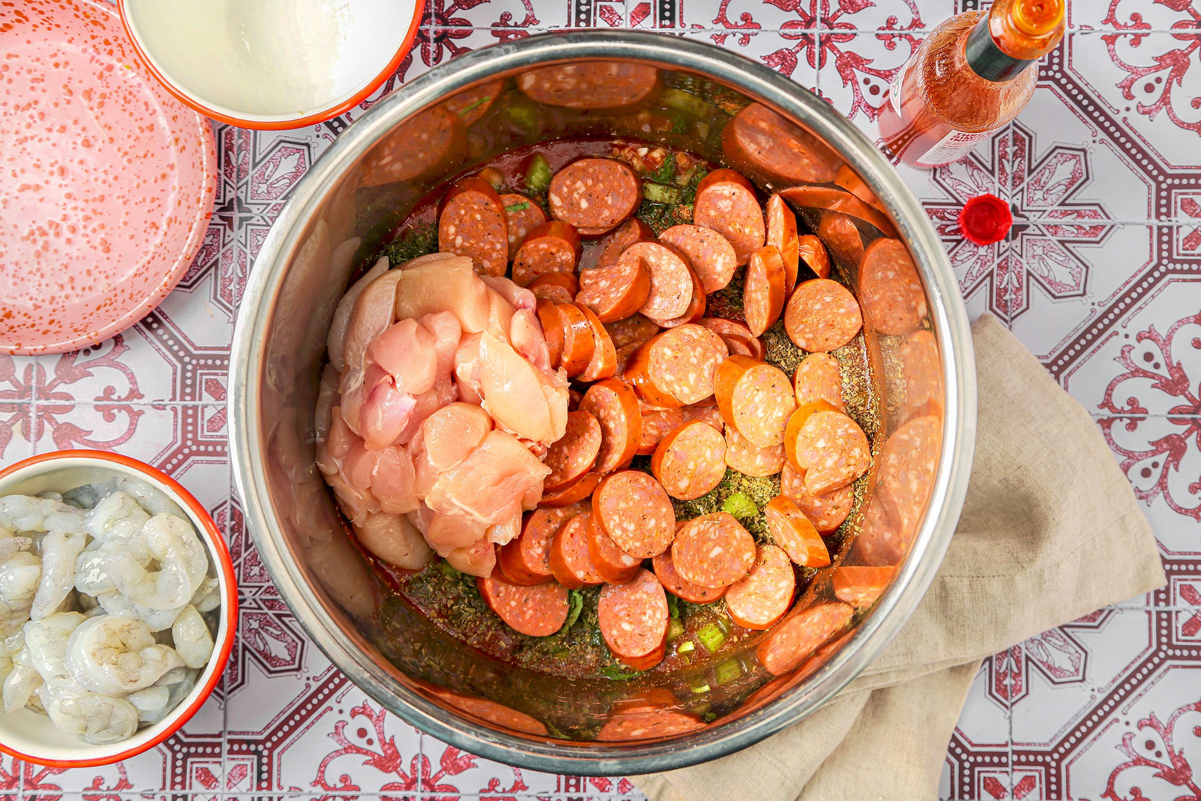 Added sausage and chicken in cooker with Jambalaya ingredients