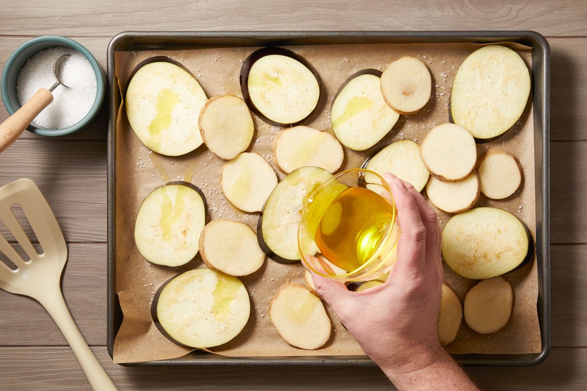 Place potato and eggplant on a parchment or foil-lined baking sheet. drizzle with ghee