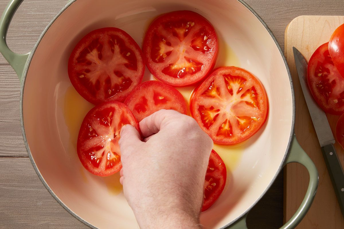 Layer tomatoes over bottom of the pot.