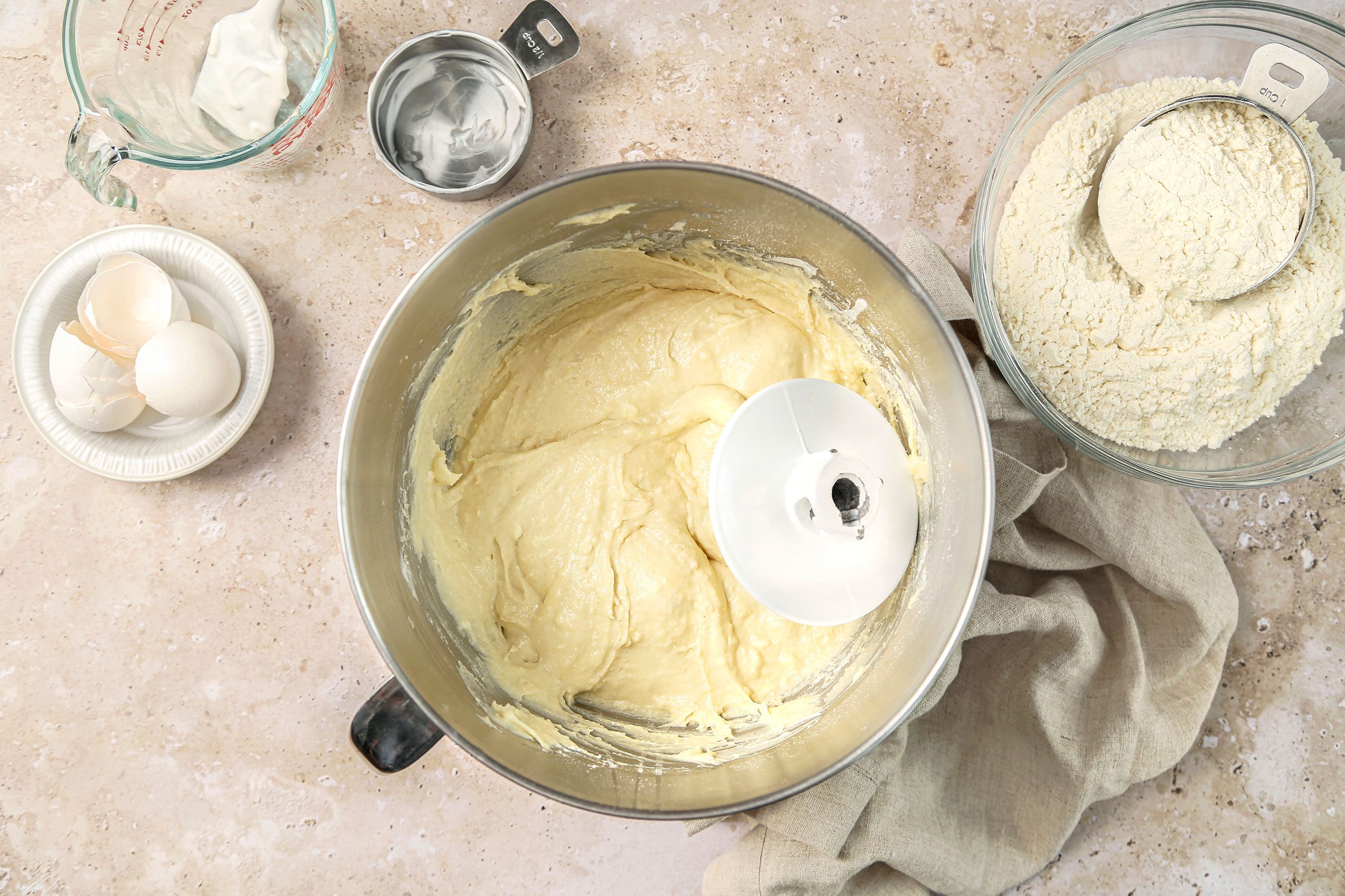 Sugar, salt, butter, sour cream, eggs and 3 cups of the flour beaten together in milk in a large mixing bowl