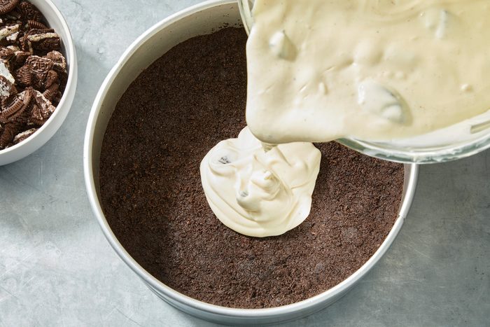 Overhaed shot of pour into crust; on a grey surface;