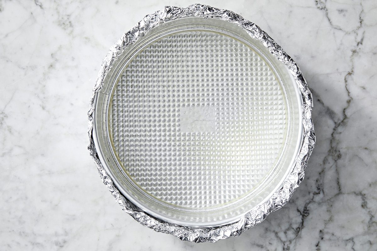 Overhead shot of place a greased 9-inch springform pan on a double thickness of heavy-duty foil; securely wrap foil around pan