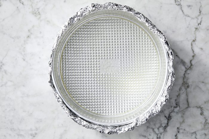 Overhead shot of place a greased 9-inch springform pan on a double thickness of heavy-duty foil; securely wrap foil around pan