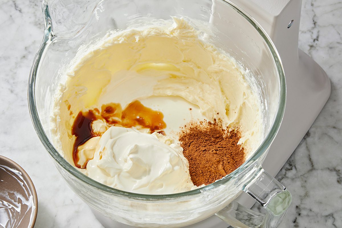 Close shot of Beat in sour cream; buttermilk; cocoa and vanilla until smooth
