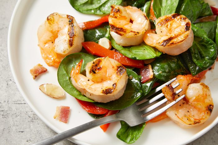 Close up shot of Shrimp and Spinach Salad with Hot Bacon Dressing;