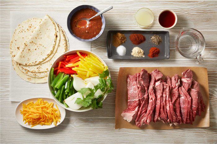 Overhead shot of ingredients on the kitchen counter on a light wooden countertop.