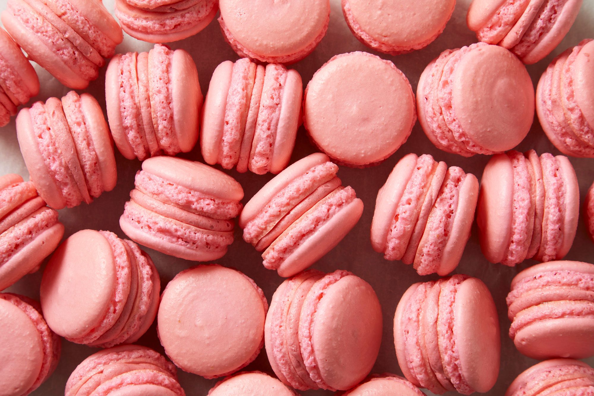 Top view shot of Strawberry Macarons; placed over wax sheet