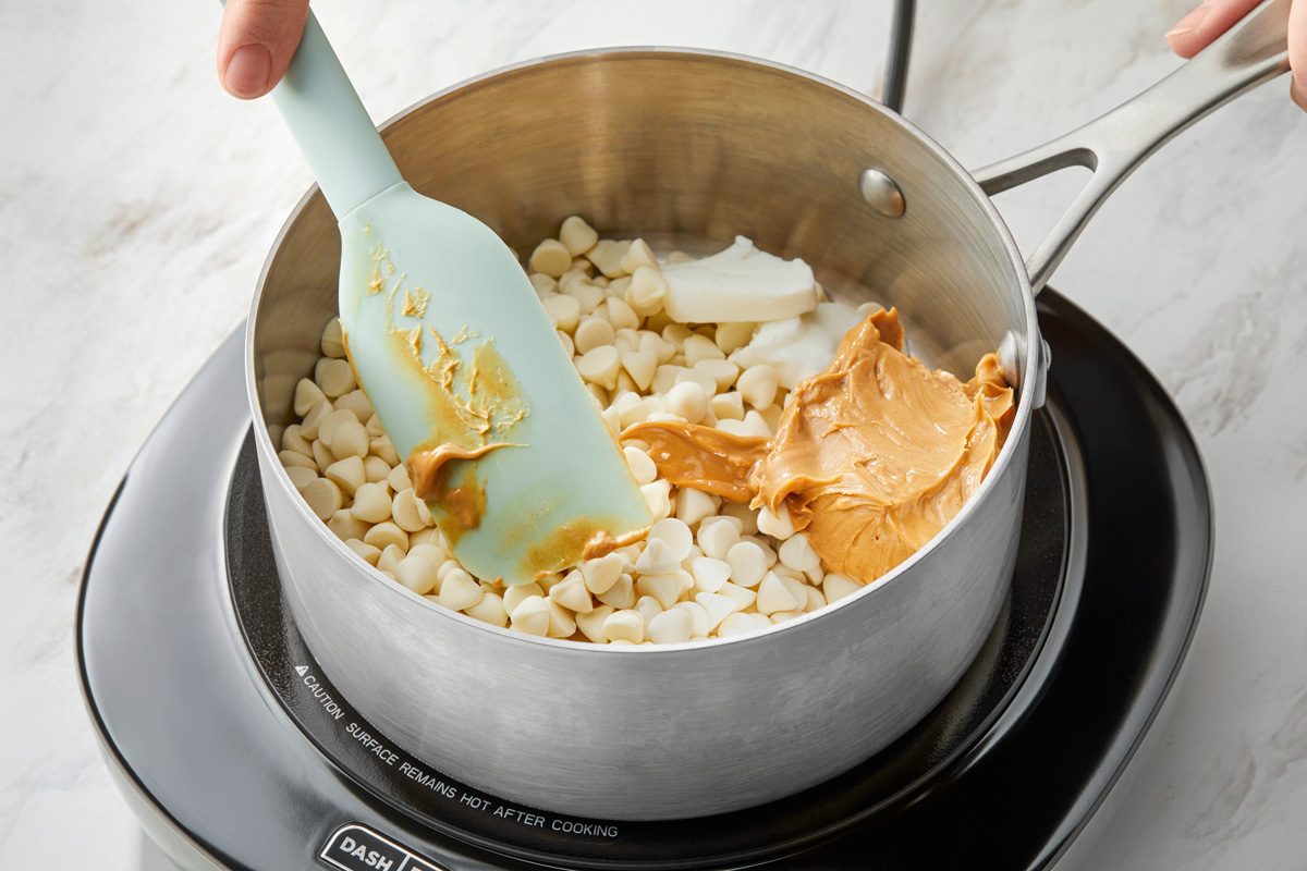 A heavy saucepan with vanilla chips and peanut butter