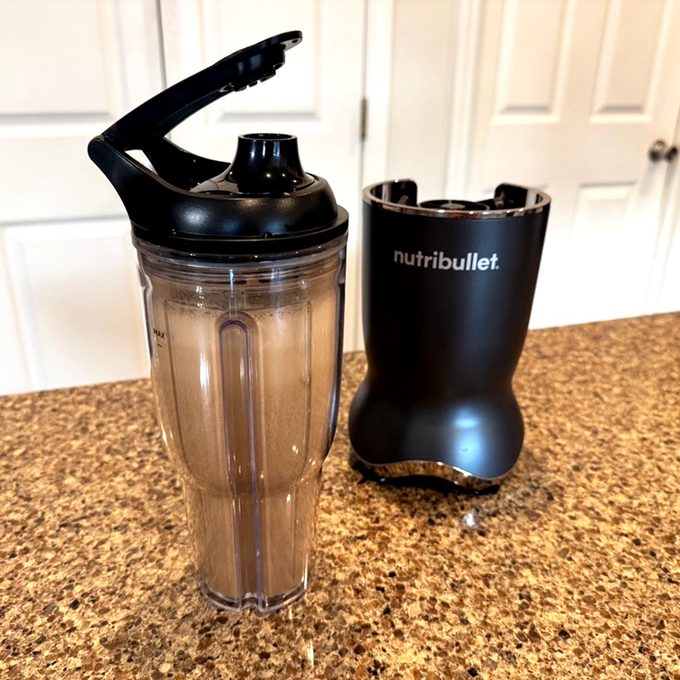 Nutribullet base with smoothie cup attachment on a kitchen counter