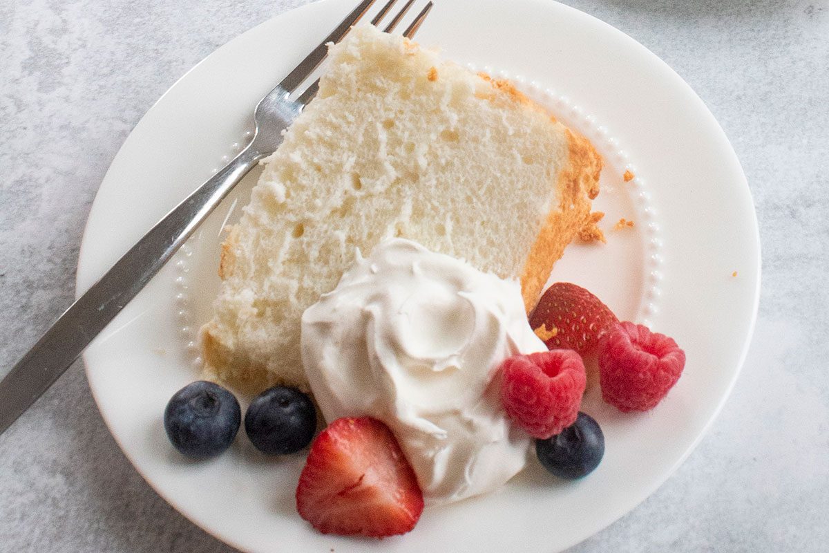 A piece of angel food cake in a plate, ready to serve
