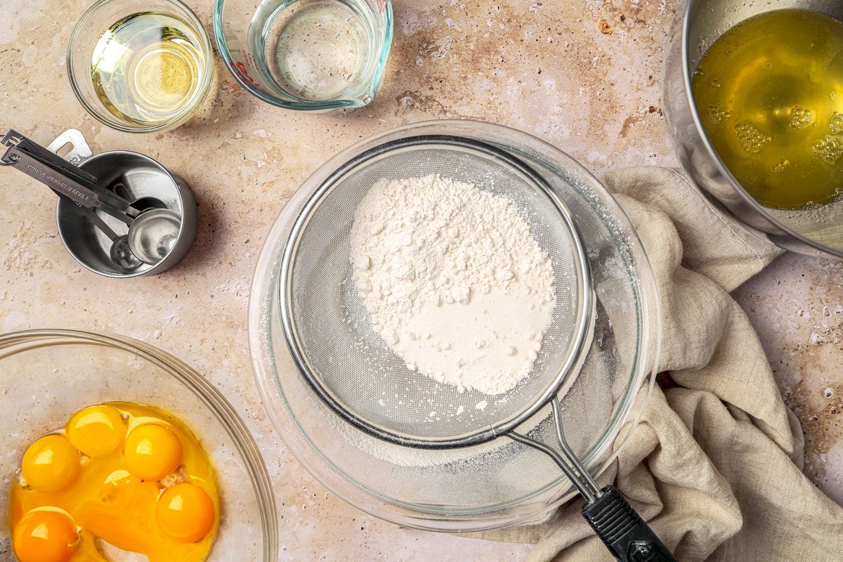 Place egg whites in a large bowl and in another bowl mix flour; sugar; salt and baking soda