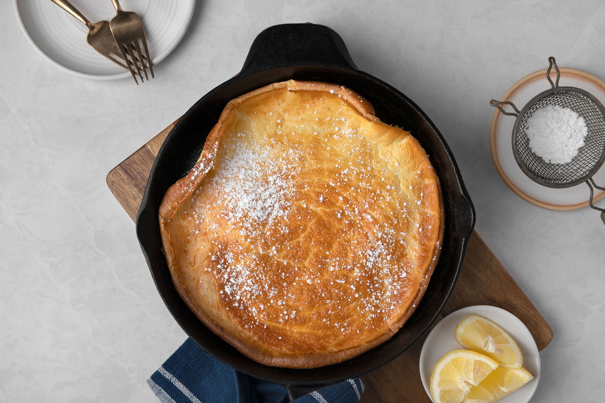 Hot pancake cooked in a large skillet and dusted with confectioners' sugar