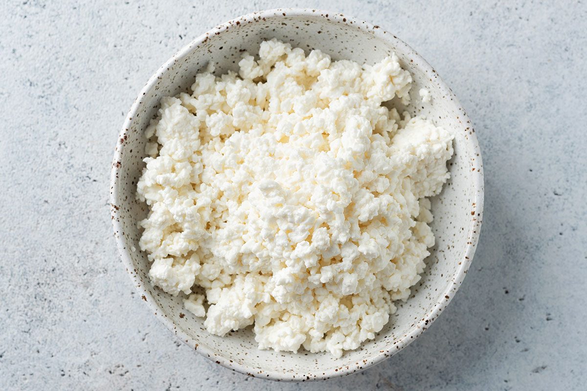 Cottage cheese or curd cheese crumbs in a bowl