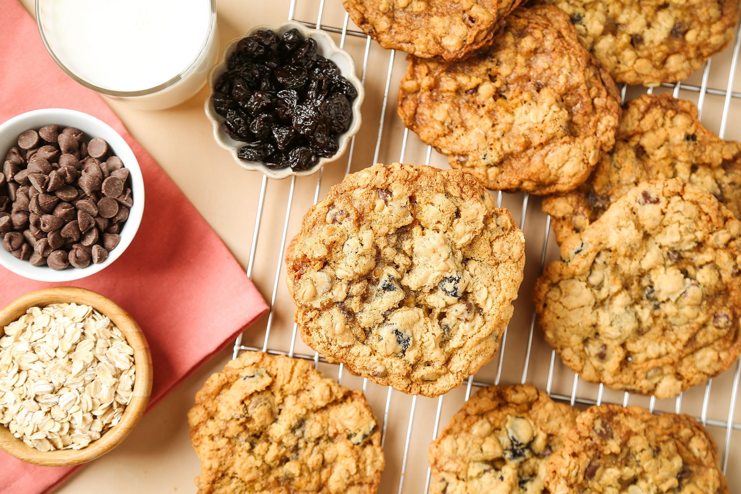 Oatmeal Cherry Cookies with dried cherries, milk, oats and chocolate chips on side
