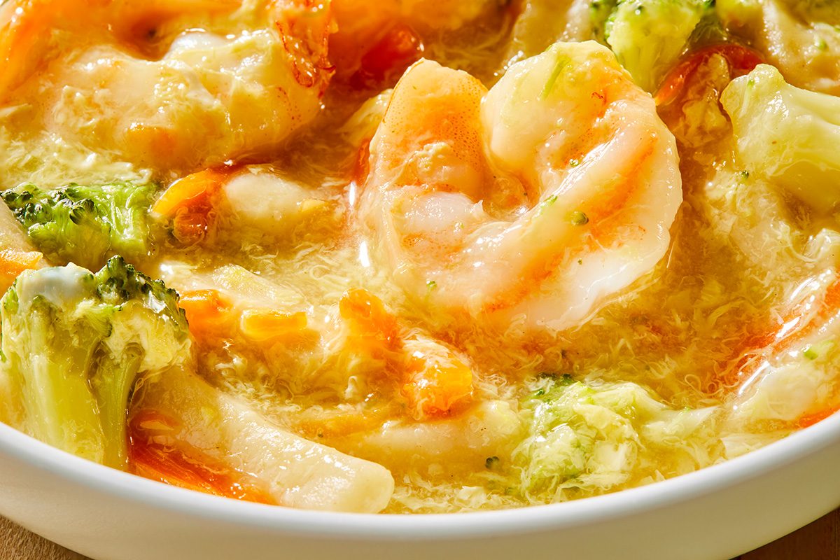 Push shot of a bowl of Shrimp Egg Drop Soup; the serving bowl is white and round