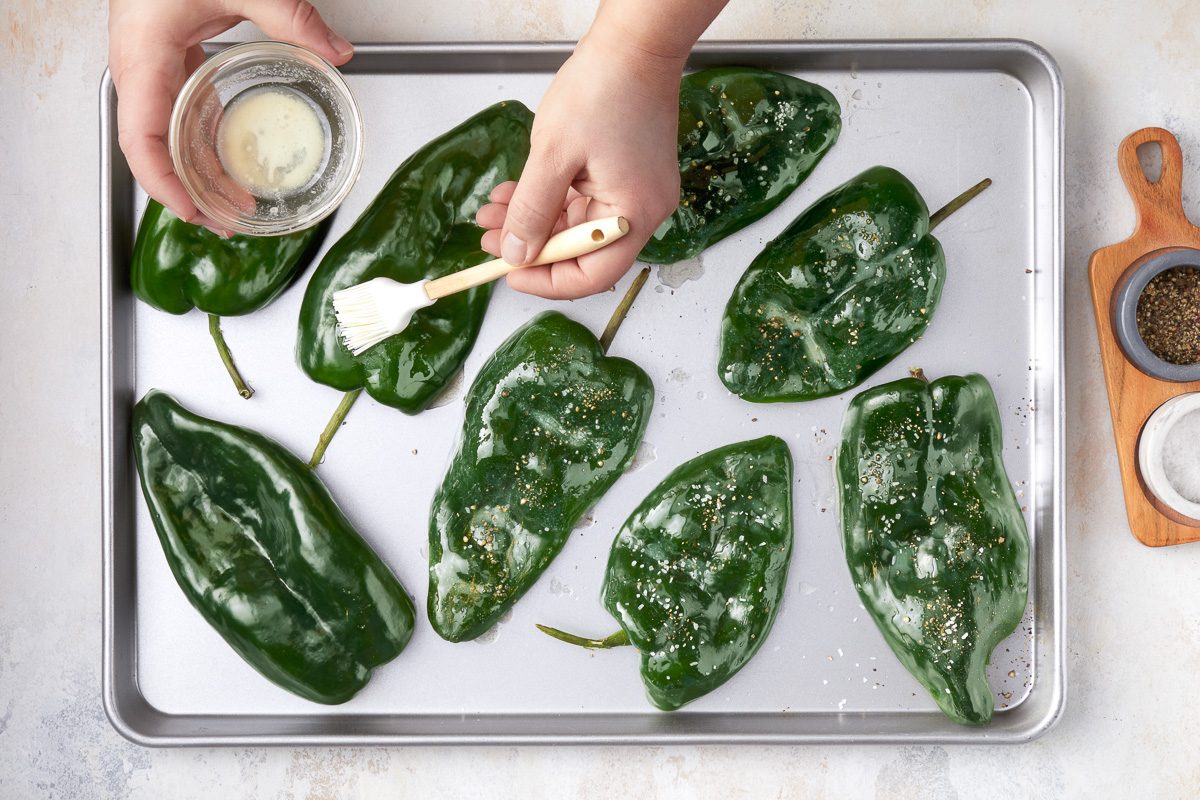 brushing peppers with melted butter
