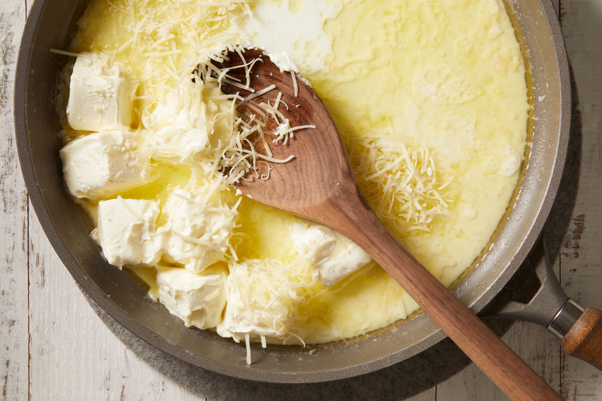 In the same skillet, combine the cream cheese, milk and Parmesan cheese; cook and stir until cheeses are melted and mixture is smooth.