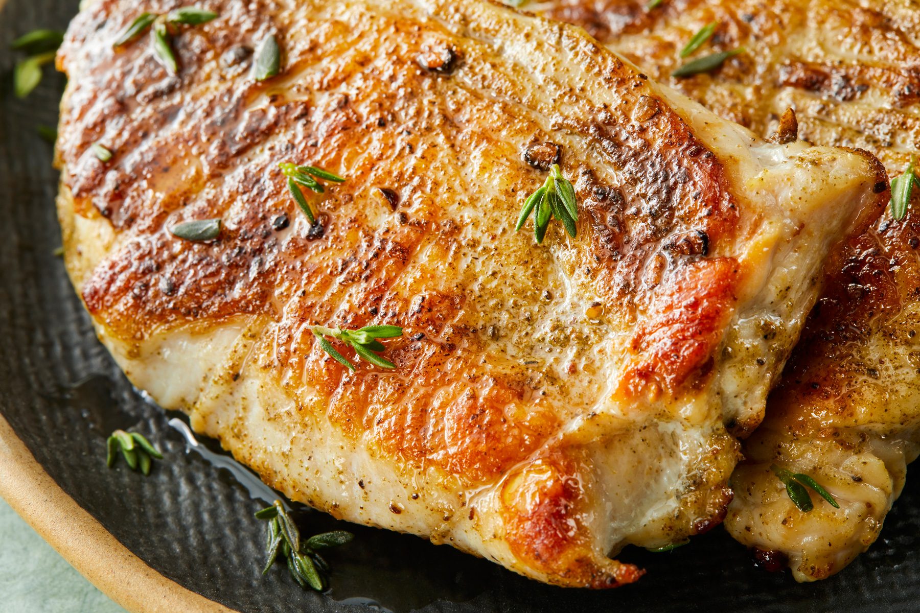 Close-up shot of Turkey Cutlets with Pan Gravy; served on a large platter; on a light green surface;