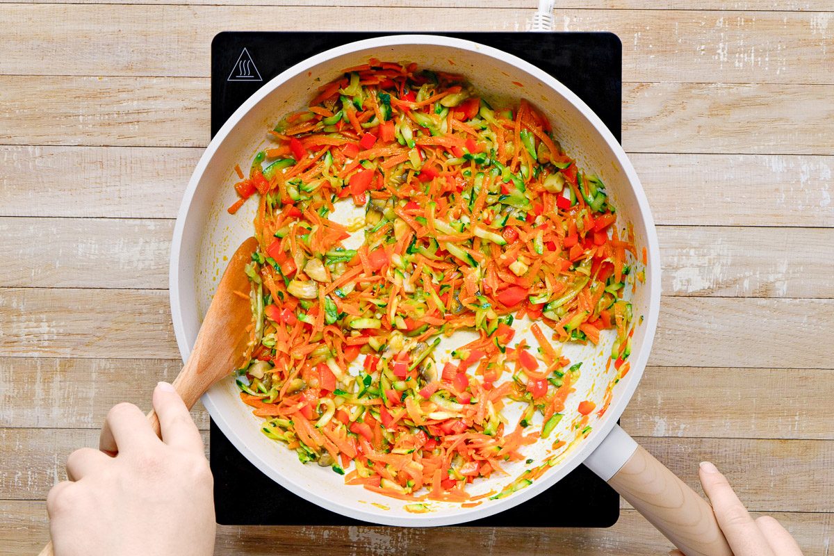 vegetables being cooked in a skillet