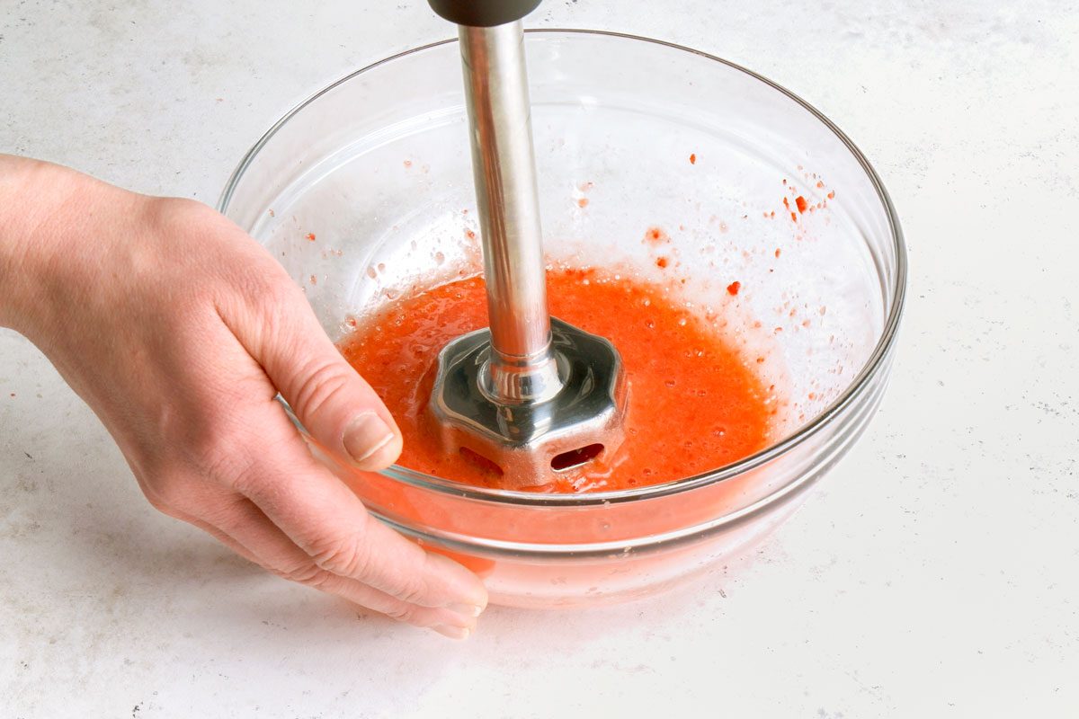 Using an immersion blender puree strawberries