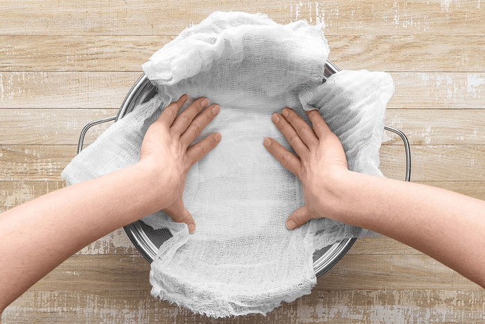 Line a large strainer with 2 layers of cheesecloth; dampened with water; place over a large bowl