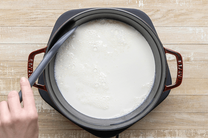 Stir in vinegar; let stand until curds form; about 5 minutes