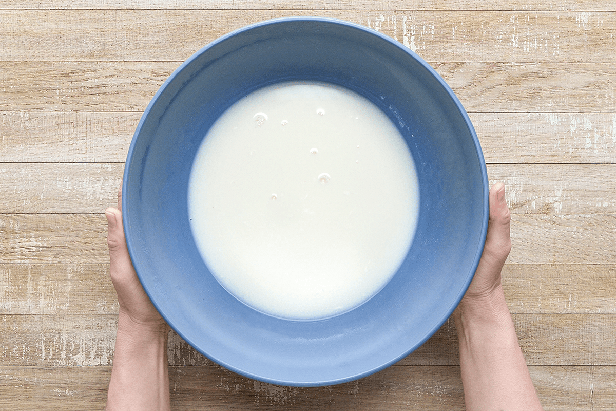 In a Dutch oven bring milk; cream and salt just to a boil over medium heat