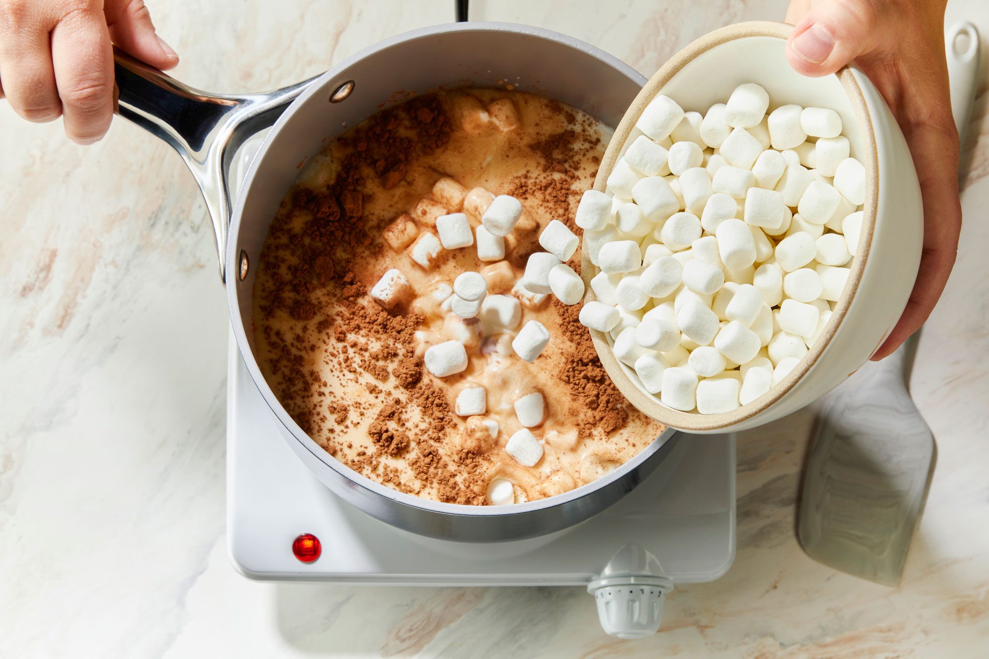 overhead shot of a small saucepan; combine the first four ingredients; induction; spatula; marble surface